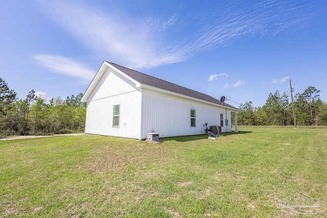 view of home's exterior featuring central air condition unit and a yard