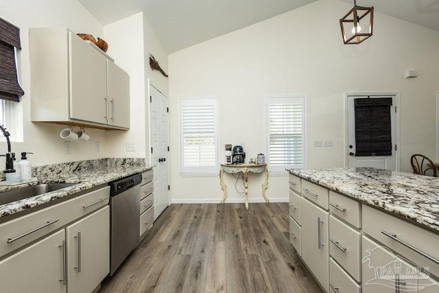 kitchen featuring vaulted ceiling, dark wood-type flooring, baseboards, stainless steel dishwasher, and a sink
