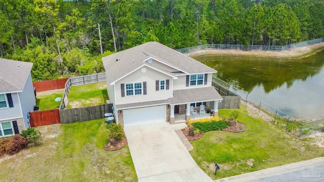 8626 Bucklebury Dr, Pensacola, FL 32507 - view of front of house featuring a shingled roof, a water view, an attached garage, driveway, and a forest view