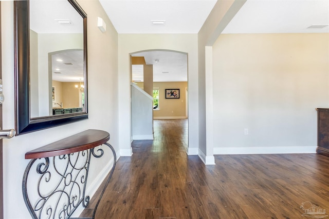 8626 Bucklebury Dr, Pensacola, FL 32507 - corridor featuring visible vents, baseboards, wood finished floors, and arched walkways