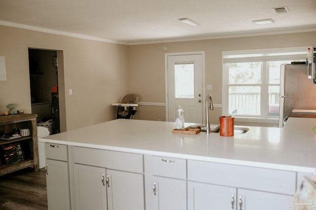 3125 Zepp Ln, Pace, FL 32571 - kitchen with freestanding refrigerator, crown molding, light countertops, dark wood finished floors, and a peninsula