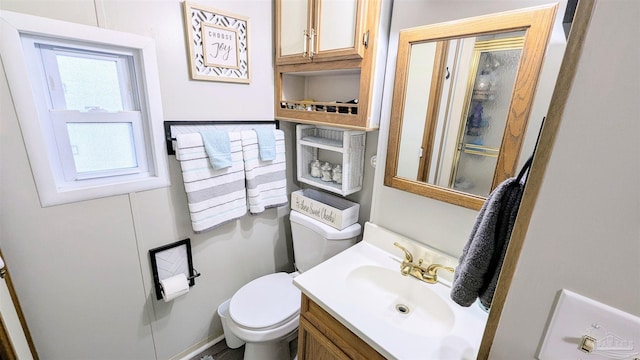 bathroom with a wealth of natural light, vanity, and toilet