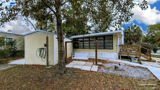 view of outbuilding featuring a sunroom