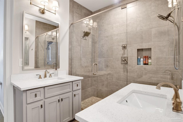 full bath with a shower stall and vanity