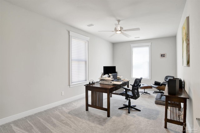 carpeted home office with visible vents, ceiling fan, and baseboards