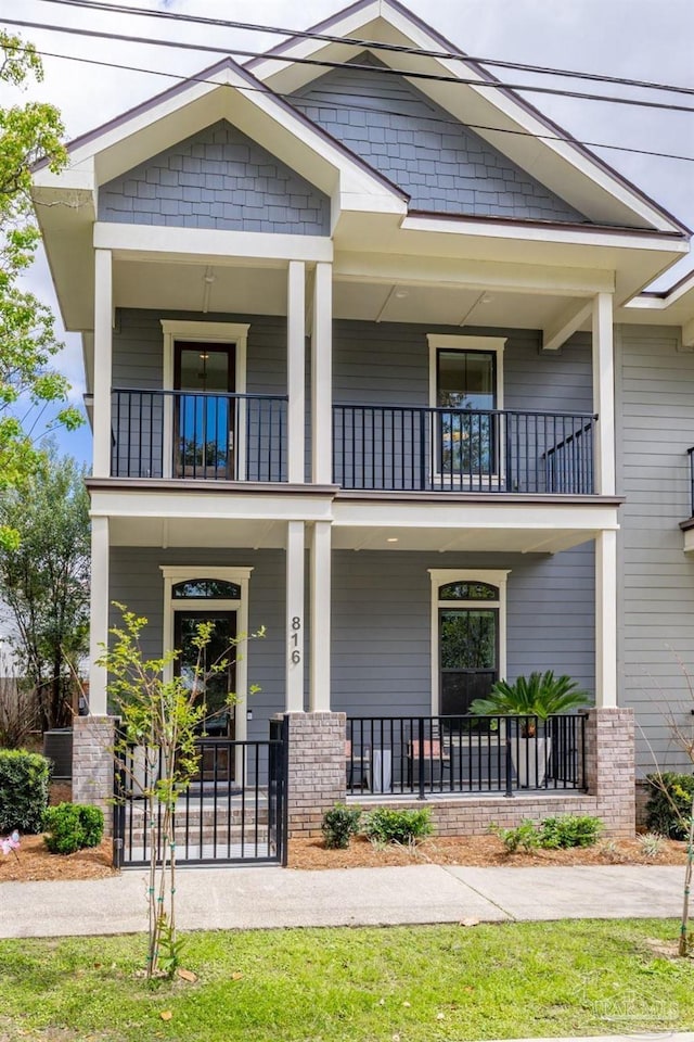 view of front of property with a porch and a balcony