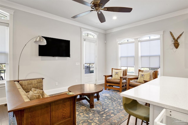 living area with ornamental molding, wood finished floors, recessed lighting, baseboards, and ceiling fan