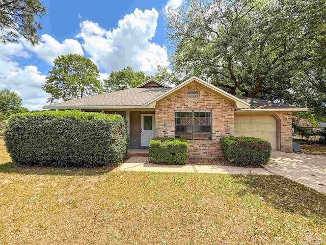 ranch-style home featuring driveway, an attached garage, brick siding, and a front yard