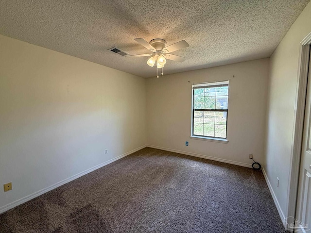 unfurnished room featuring a textured ceiling, visible vents, a ceiling fan, and dark carpet