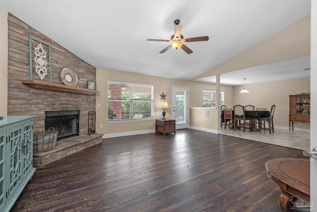 living room with ceiling fan, a stone fireplace, high vaulted ceiling, and dark hardwood / wood-style flooring