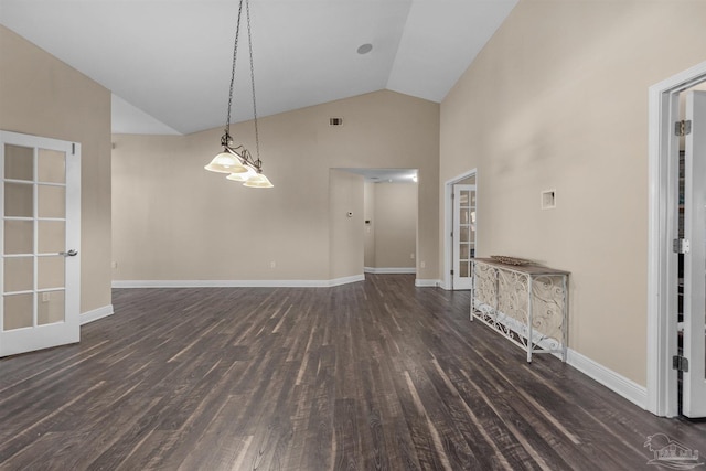 unfurnished living room featuring high vaulted ceiling and dark wood-type flooring