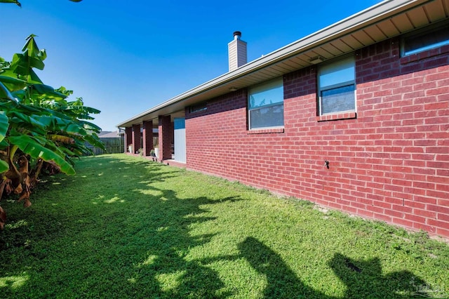 view of property exterior with a yard