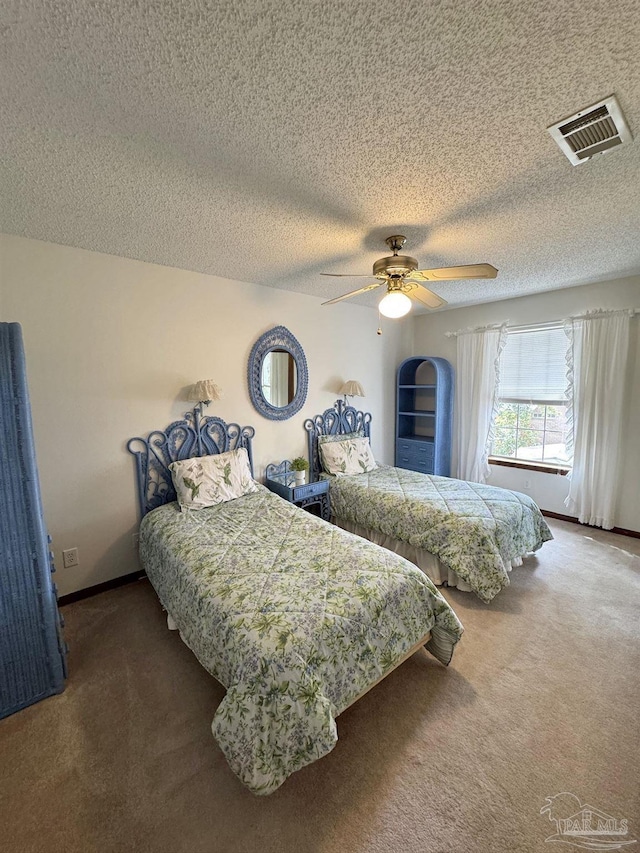 carpeted bedroom with a textured ceiling and ceiling fan