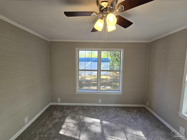 carpeted empty room with baseboards, crown molding, and ceiling fan