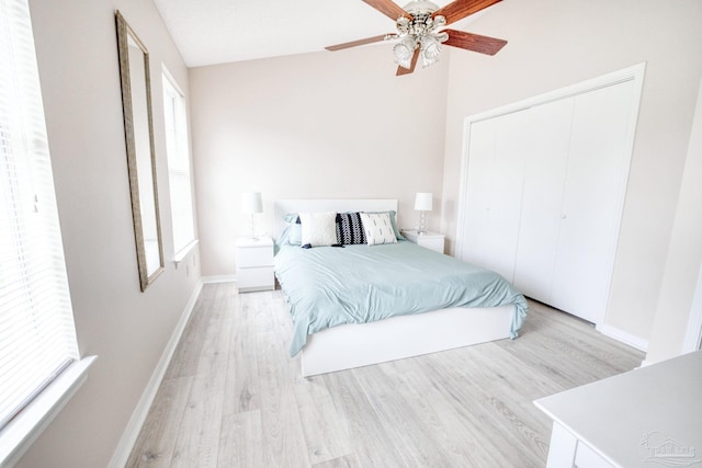 bedroom featuring ceiling fan, light hardwood / wood-style floors, and a closet