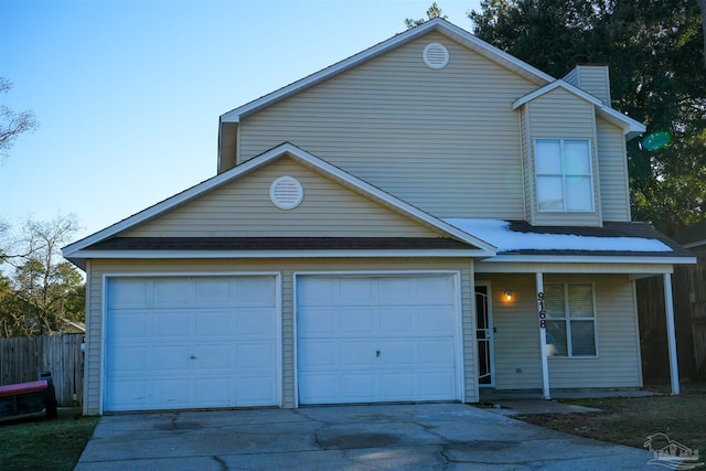 view of property with a garage and covered porch