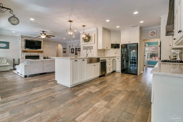 kitchen with white cabinetry, pendant lighting, sink, and black appliances