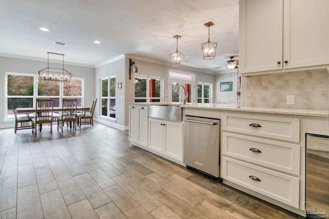 kitchen with sink, dishwasher, backsplash, wine cooler, and decorative light fixtures