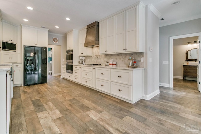 kitchen with white cabinetry, crown molding, custom range hood, stainless steel appliances, and backsplash