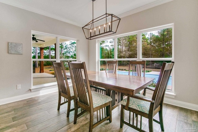 dining space featuring ornamental molding, a chandelier, and hardwood / wood-style floors