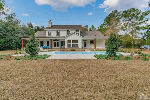 back of property featuring a yard and a patio area