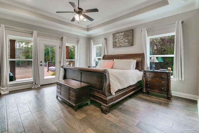 bedroom with access to exterior, ornamental molding, a raised ceiling, and light wood-type flooring