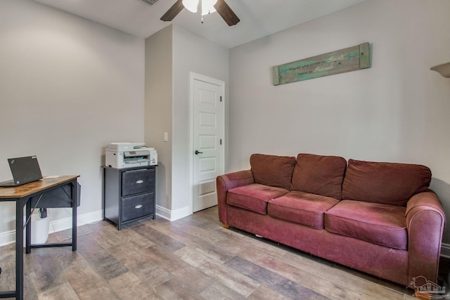 living room featuring ceiling fan and light hardwood / wood-style floors