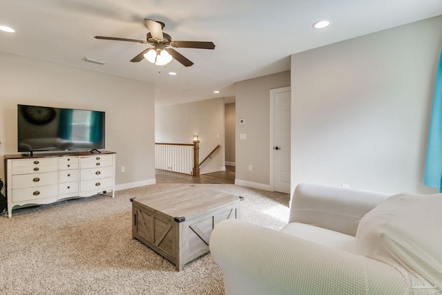 living room with ceiling fan and light colored carpet