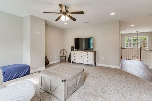 living room featuring light colored carpet and ceiling fan