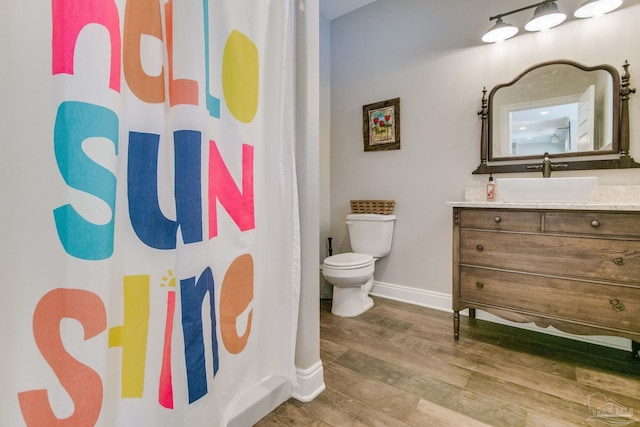 bathroom featuring hardwood / wood-style flooring, vanity, and toilet