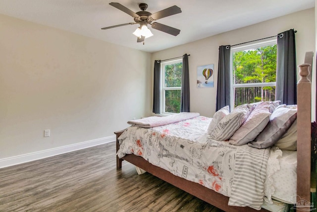 bedroom with ceiling fan and dark hardwood / wood-style flooring