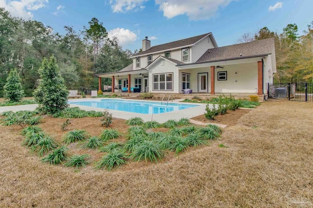 view of pool featuring a patio, a yard, and ceiling fan