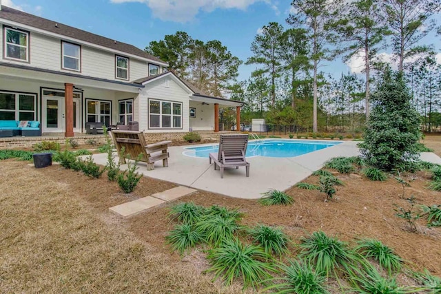 view of swimming pool featuring a patio and ceiling fan