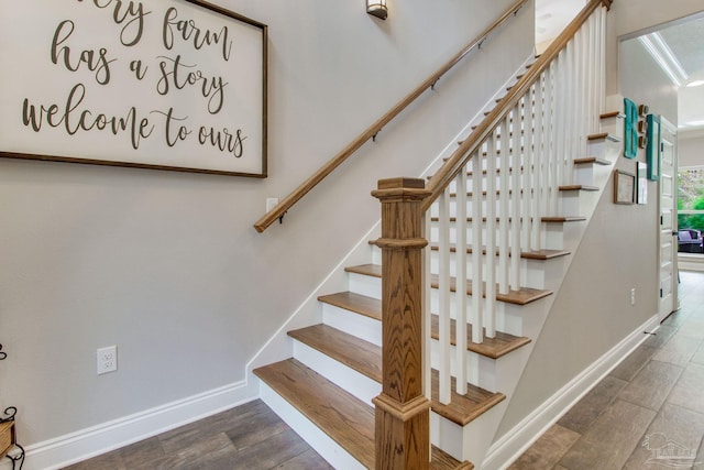 staircase with hardwood / wood-style flooring