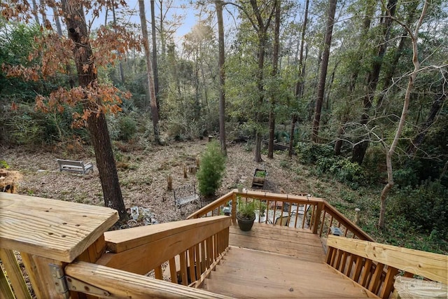 wooden deck with a view of trees