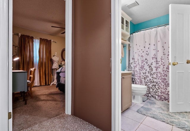 bathroom featuring visible vents, toilet, a textured ceiling, vanity, and tile patterned flooring