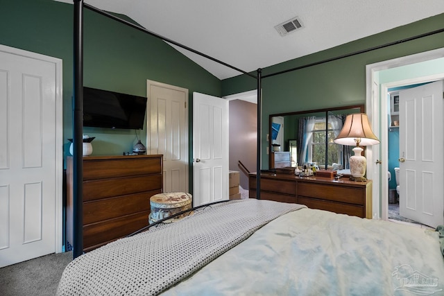 bedroom with visible vents, vaulted ceiling, and carpet flooring