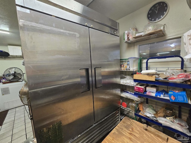 interior space featuring tile patterned flooring and stainless steel built in fridge