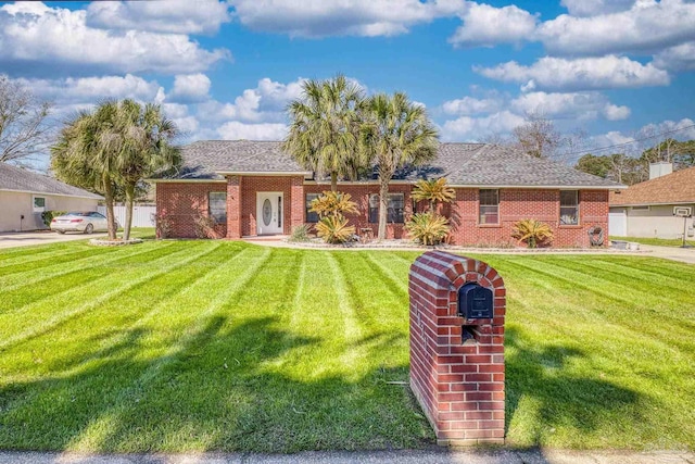 ranch-style home with a front lawn and brick siding