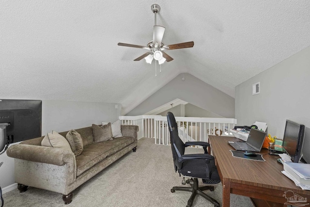 office space featuring lofted ceiling, carpet flooring, visible vents, and ceiling fan