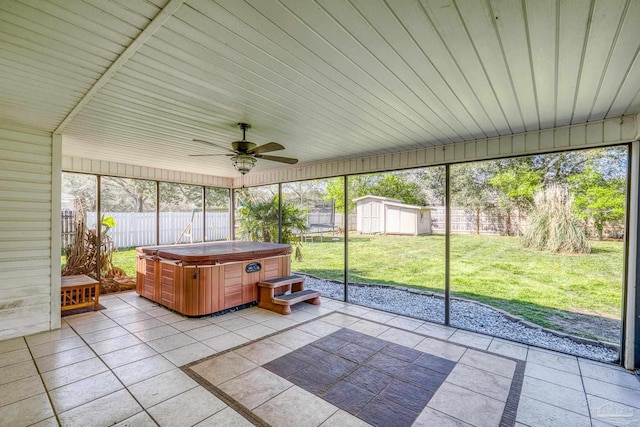 unfurnished sunroom featuring a wealth of natural light and a ceiling fan