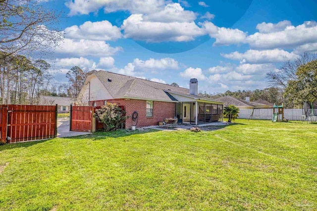 rear view of property featuring a patio, a lawn, fence, and a chimney