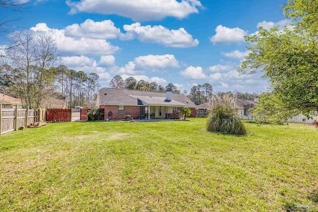 view of yard with a gate and a fenced backyard