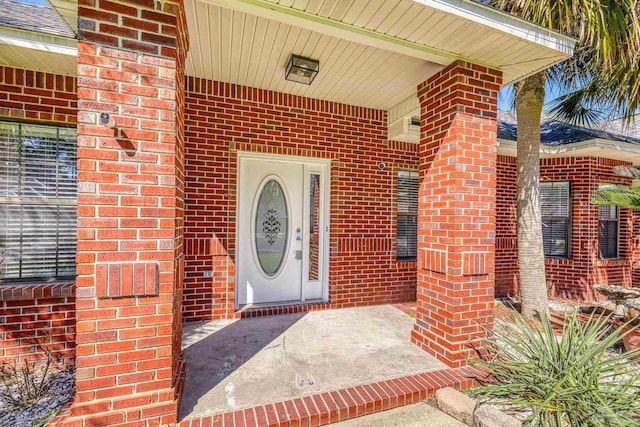 view of exterior entry with brick siding