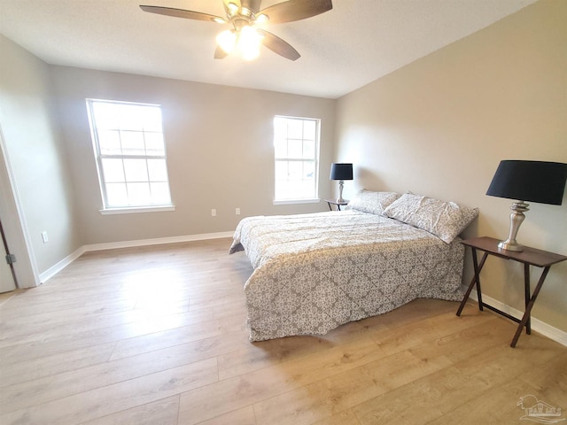 bedroom with ceiling fan and light hardwood / wood-style floors