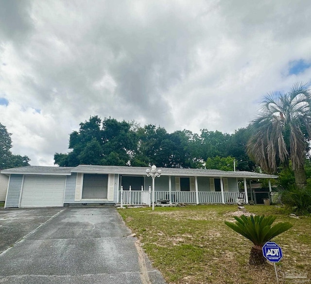 4681 Kingston Dr, Pensacola, FL 32526 - single story home with driveway, covered porch, a garage, and a front lawn