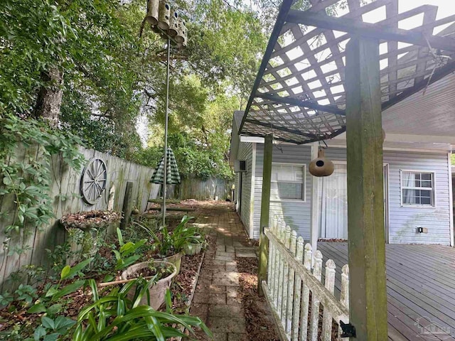 4681 Kingston Dr, Pensacola, FL 32526 - view of side of property with a fenced backyard and a wooden deck