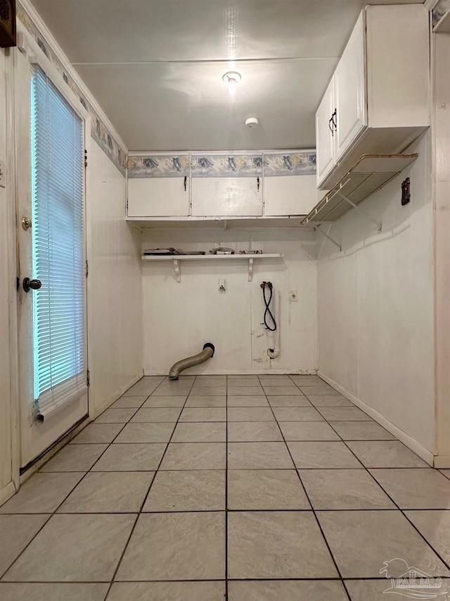 4681 Kingston Dr, Pensacola, FL 32526 - laundry area with light tile patterned floors, cabinet space, and washer hookup