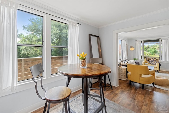 dining area featuring hardwood / wood-style floors and ornamental molding