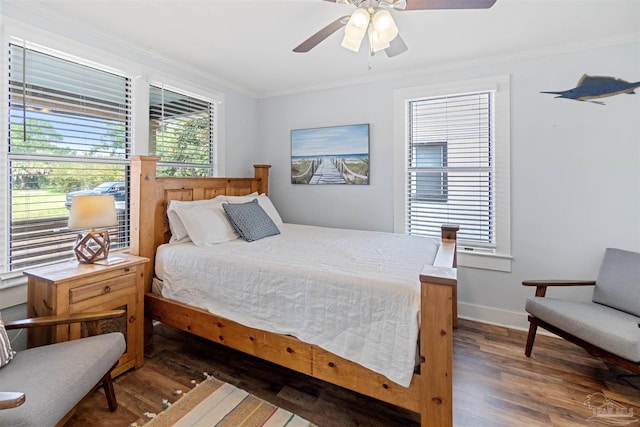 bedroom with ceiling fan, crown molding, and dark hardwood / wood-style flooring